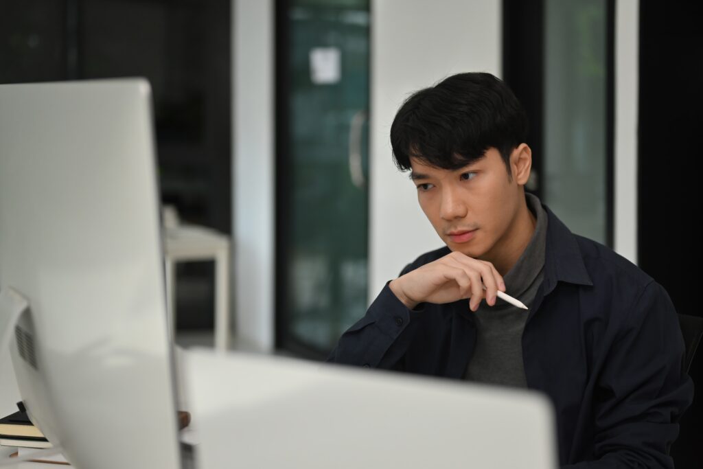 a software engineer reading something from his computer