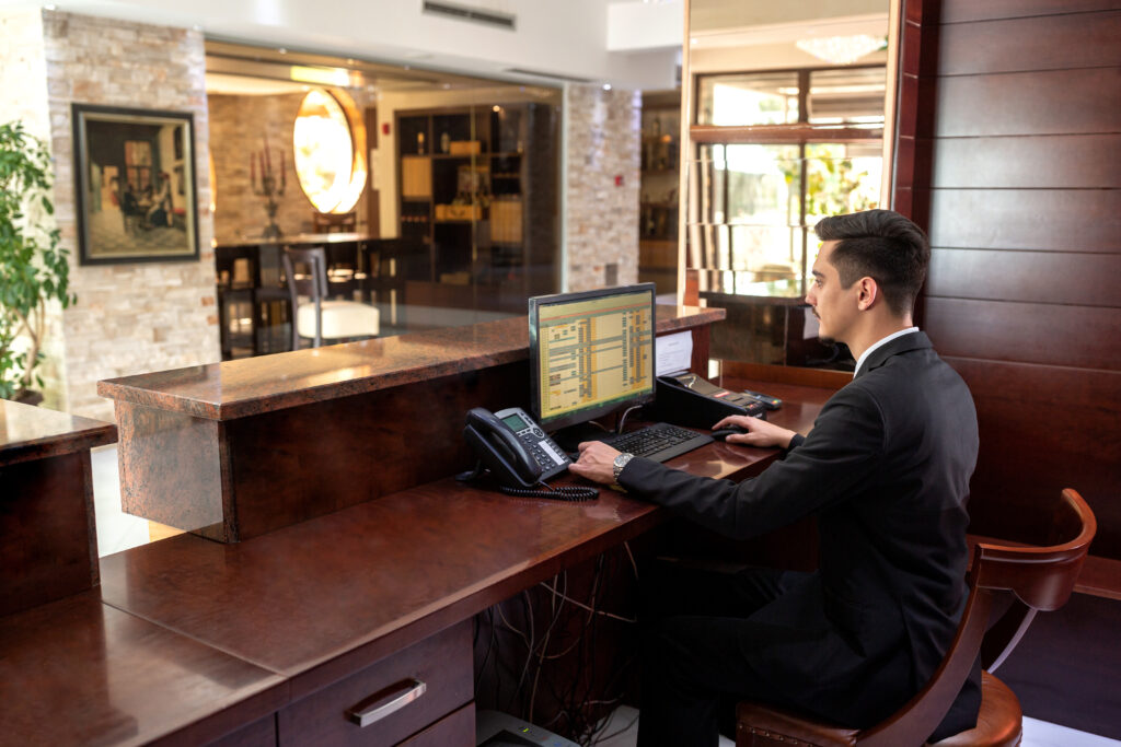 front desk hotel receptionist working while sitting in the chair
