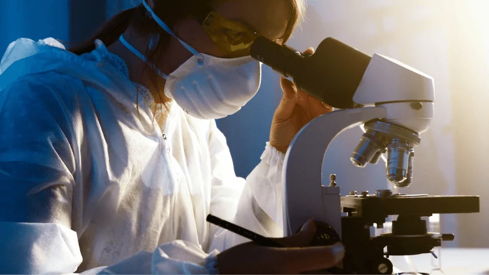 bio researcher looking at the microscope