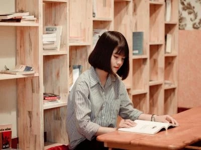 female student reading a book