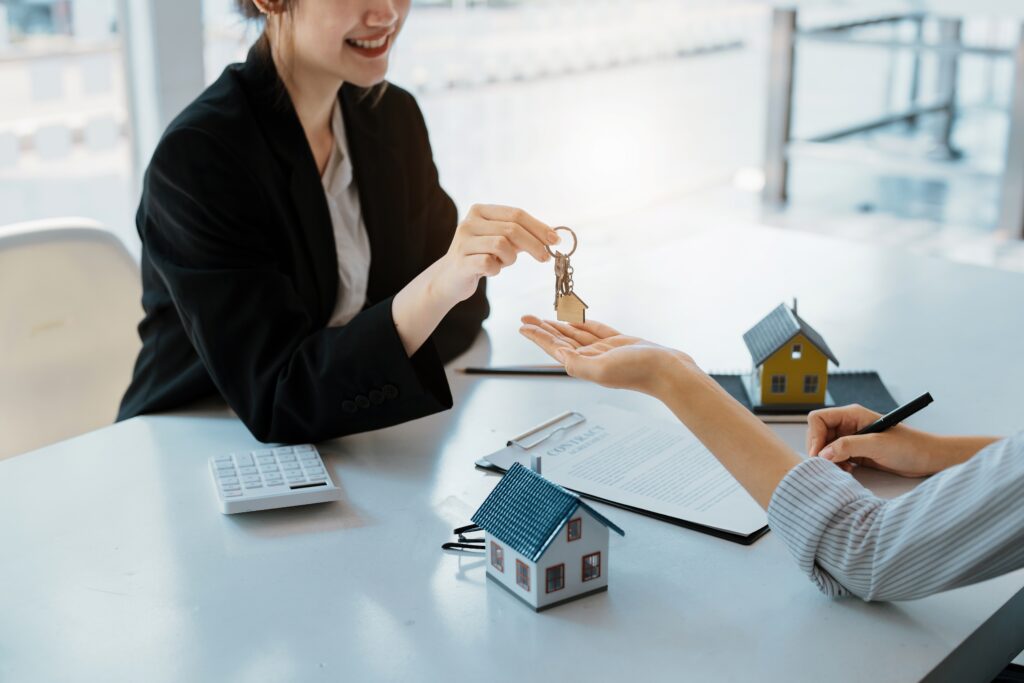 real estate agent handing over keys to a property