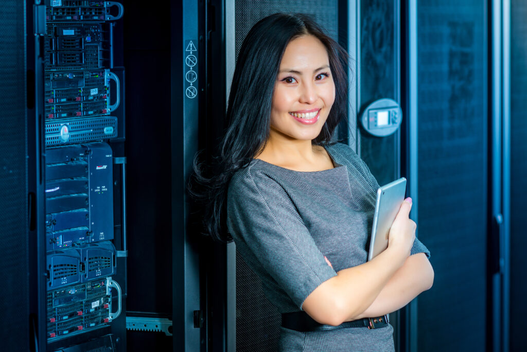 woman with a tablet exiting the network server room