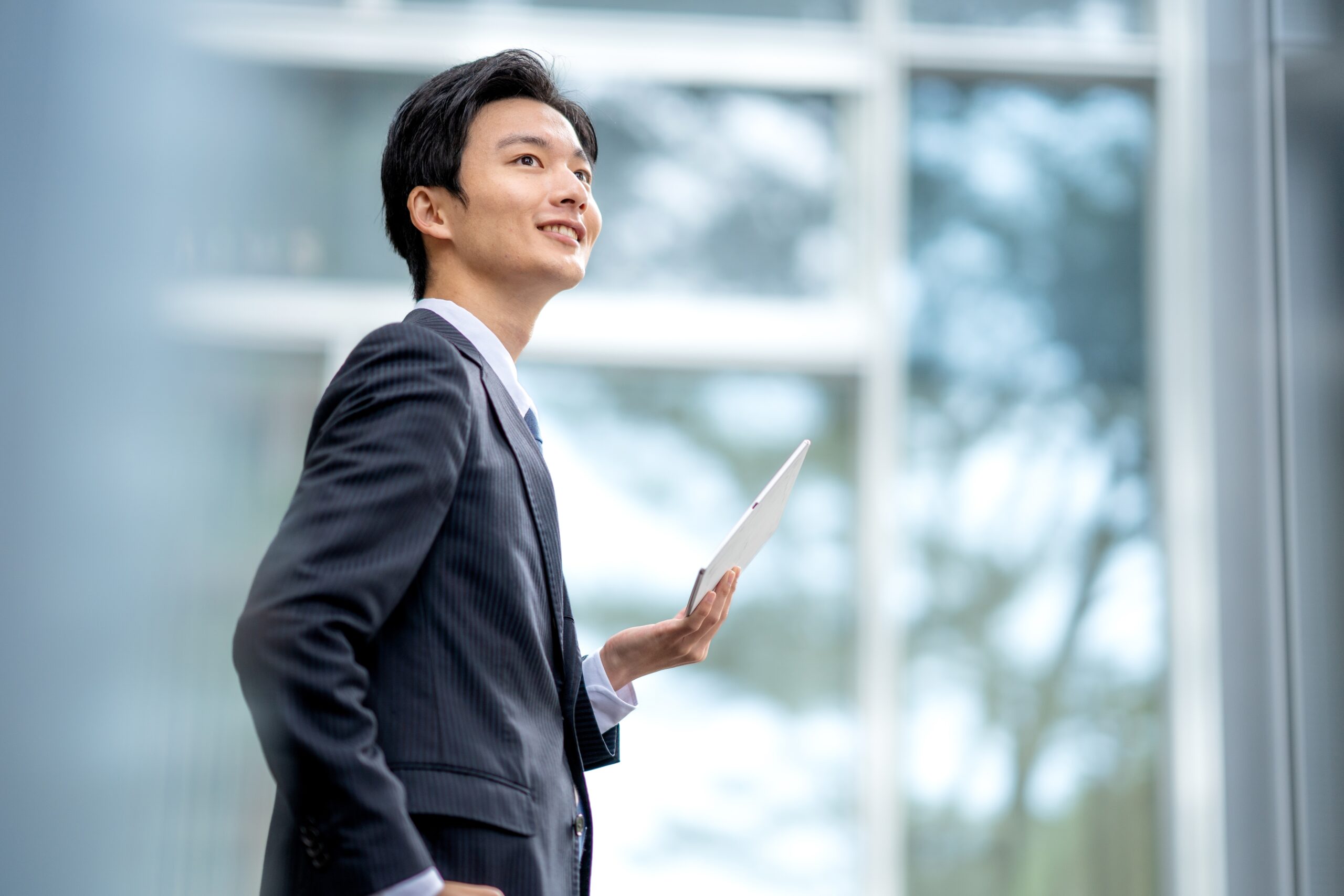 an insurance agent smiling holding a tablet