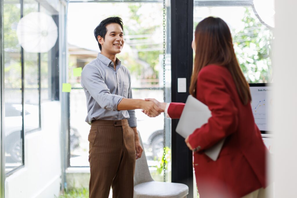 an insurance agent shaking hands with a client