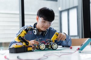 a STEM student building a robot project