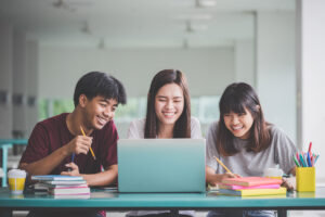 three stem students looking at a laptop