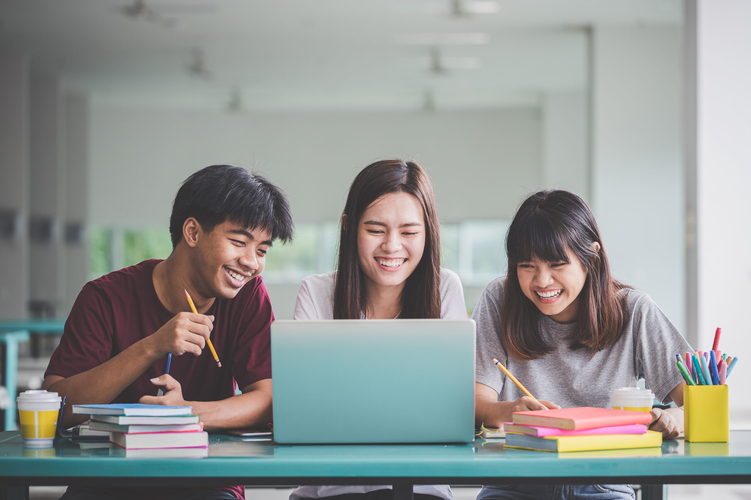three stem students looking at a laptop