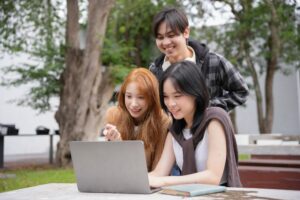 a GAS research group looking at a laptop