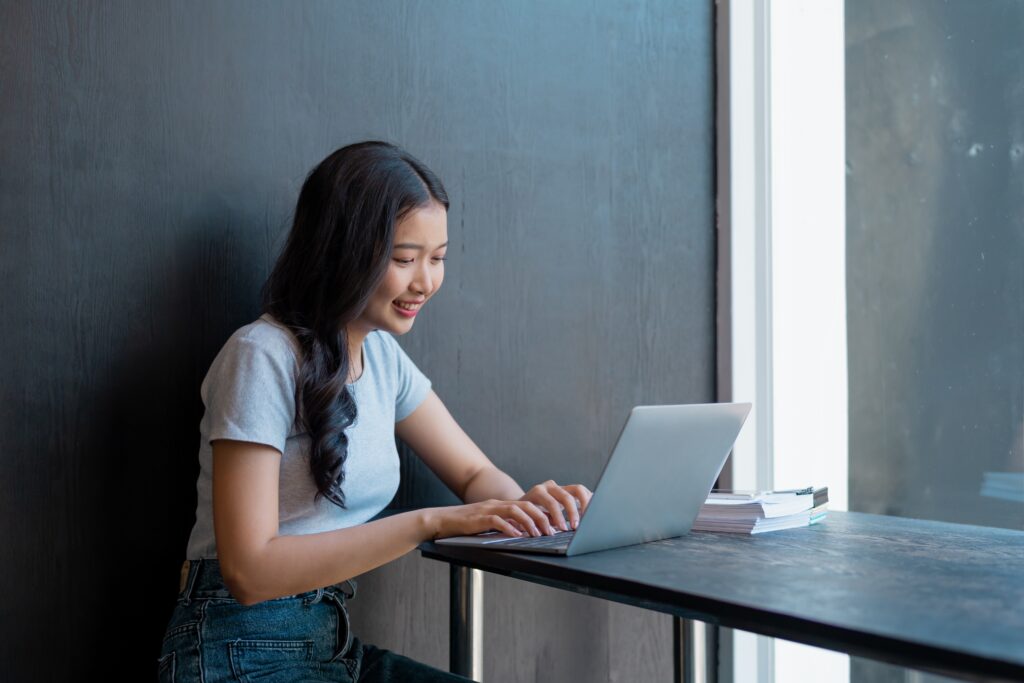 a woman attending online class in a cafe