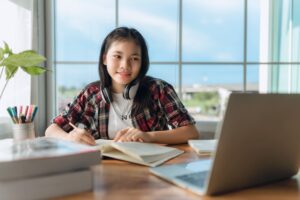 an SHS student studying with a laptop