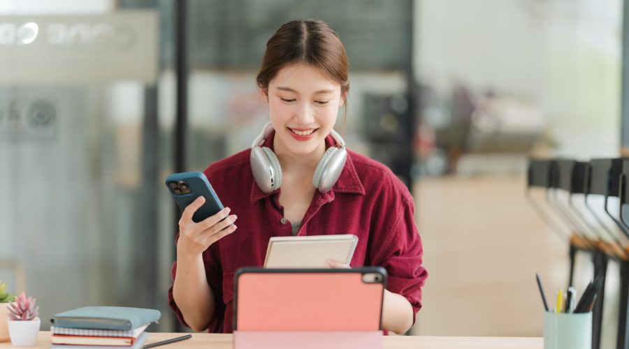 Smiling,Young,Woman,Using,Tablet,And,Smartphone