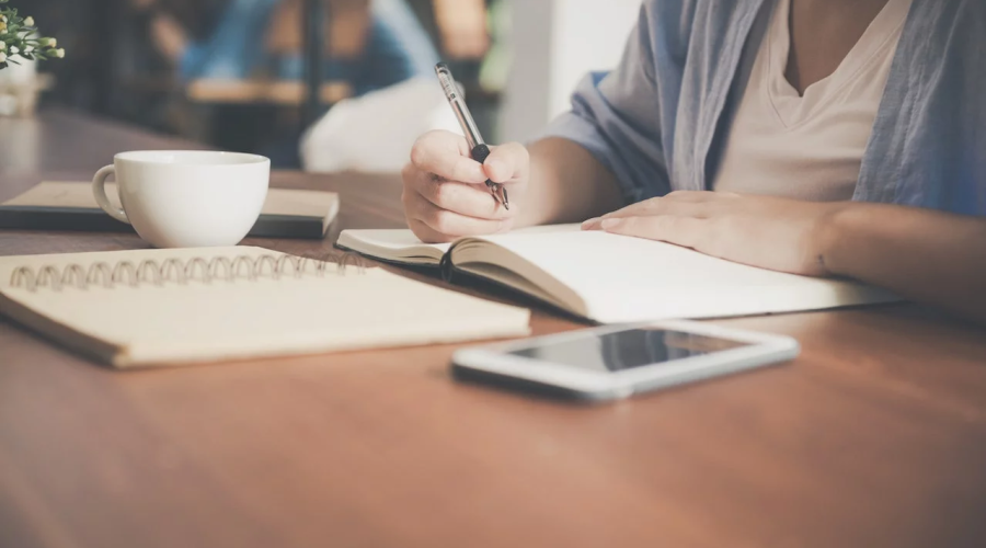 woman writing on a notebook